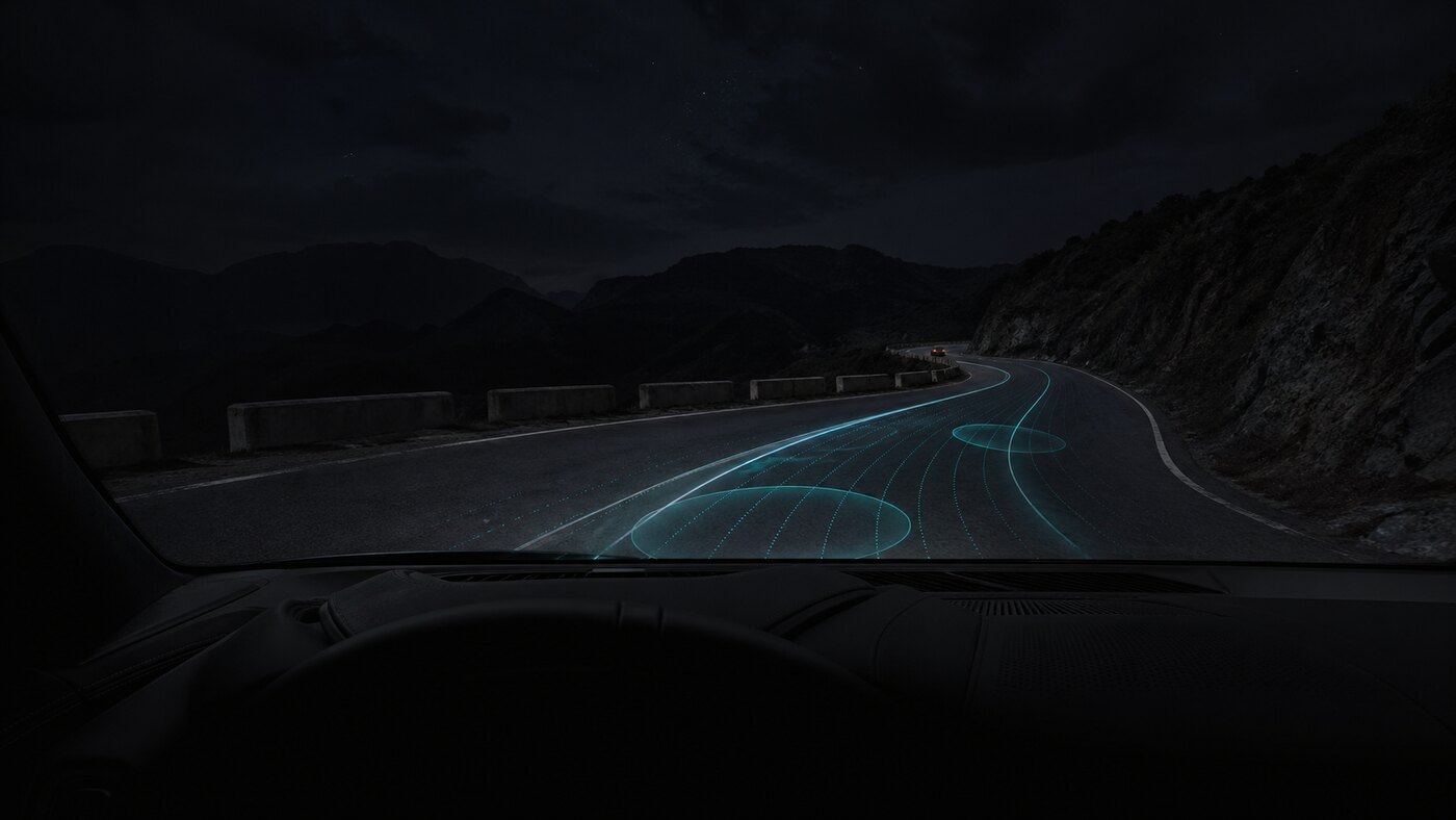 A night road with an AI racing line and grip preview overlays.